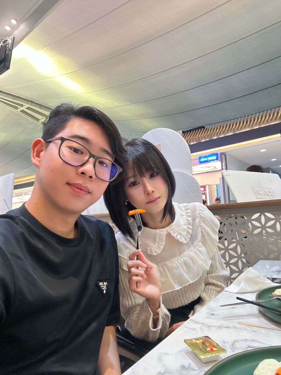 Nana holding a bite of food on a fork at dinner