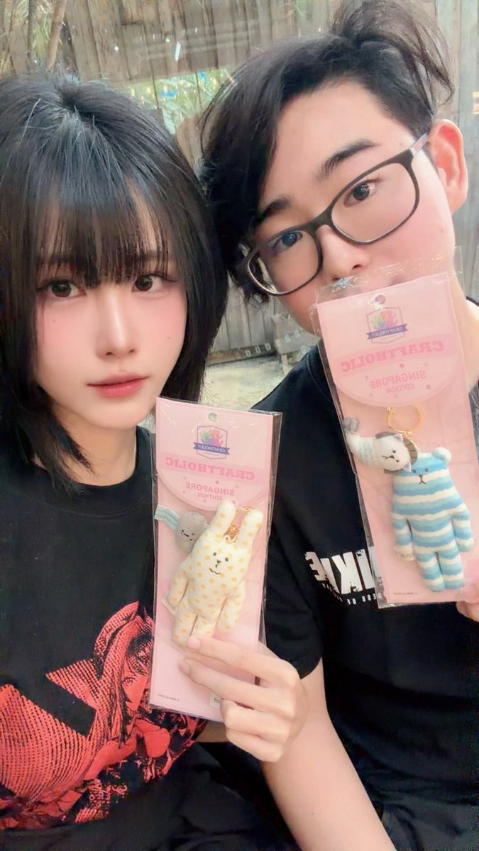 Holding matching Craftholic Singapore edition keychains
